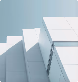 A tall white building with a sky background.