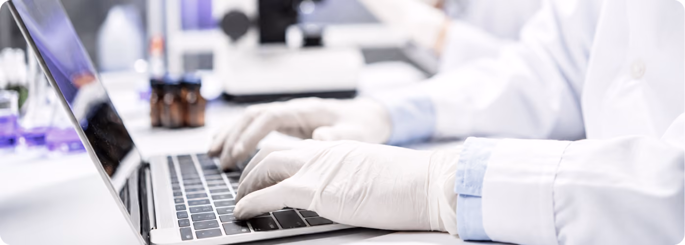 Scientist working at a laptop in a lab