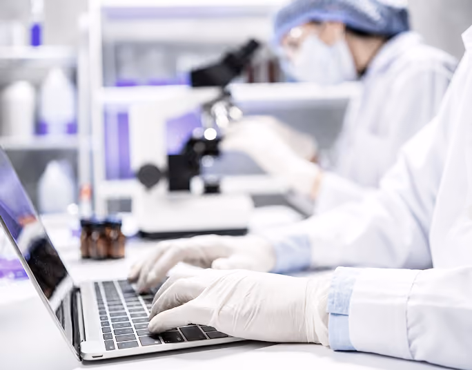 Scientist working at a laptop in a lab