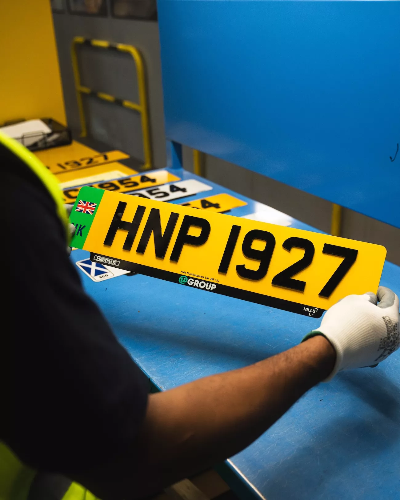 uGroup UK team member quality checking a finished number plate ready for trade reseller dispatch