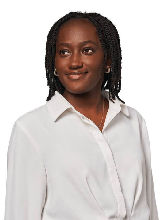 A young female professional wearing a smart-blouse and looking motivated.