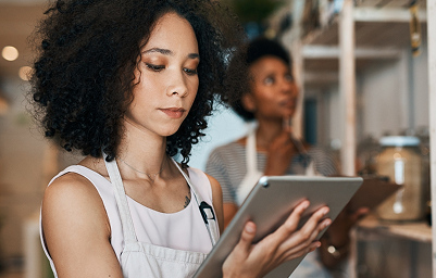 Small cafe owners reviewing POS data, showing Modern Blueprint’s business efficiency solutions