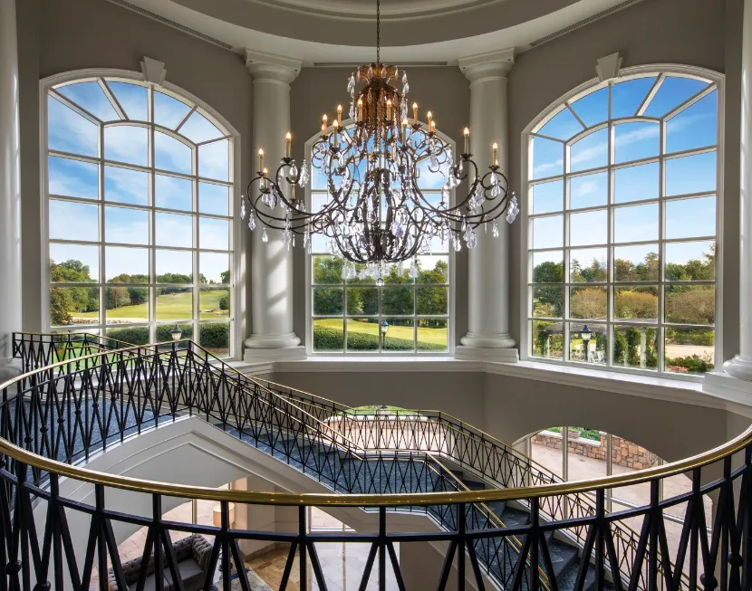 A Large Room With A Large Glass Window And A Large Chandelier