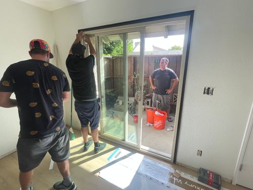 Contractor and construction crew remodeling a doorway