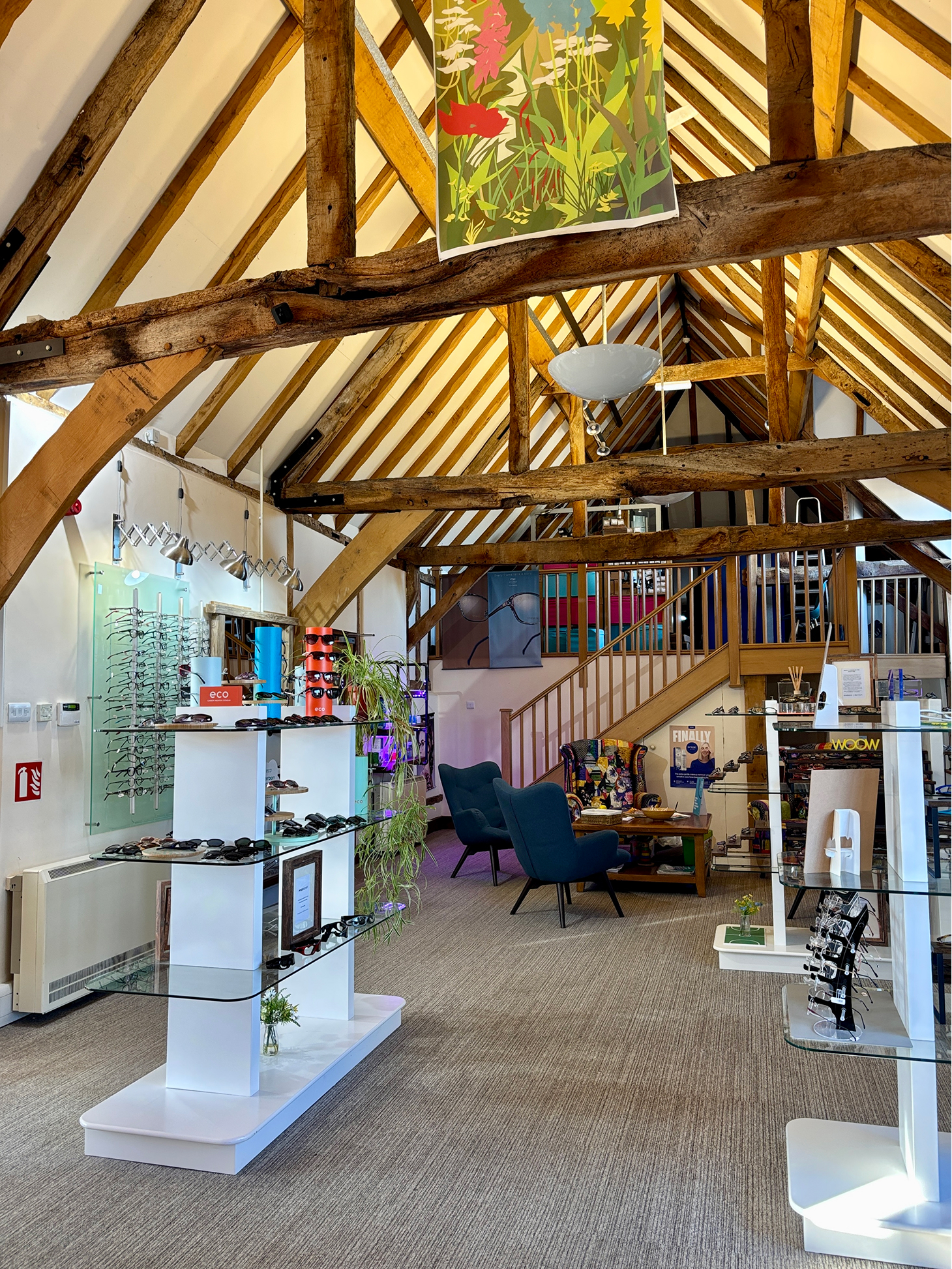 Eyewear shop with wooden beams, glass displays, and colorful artwork