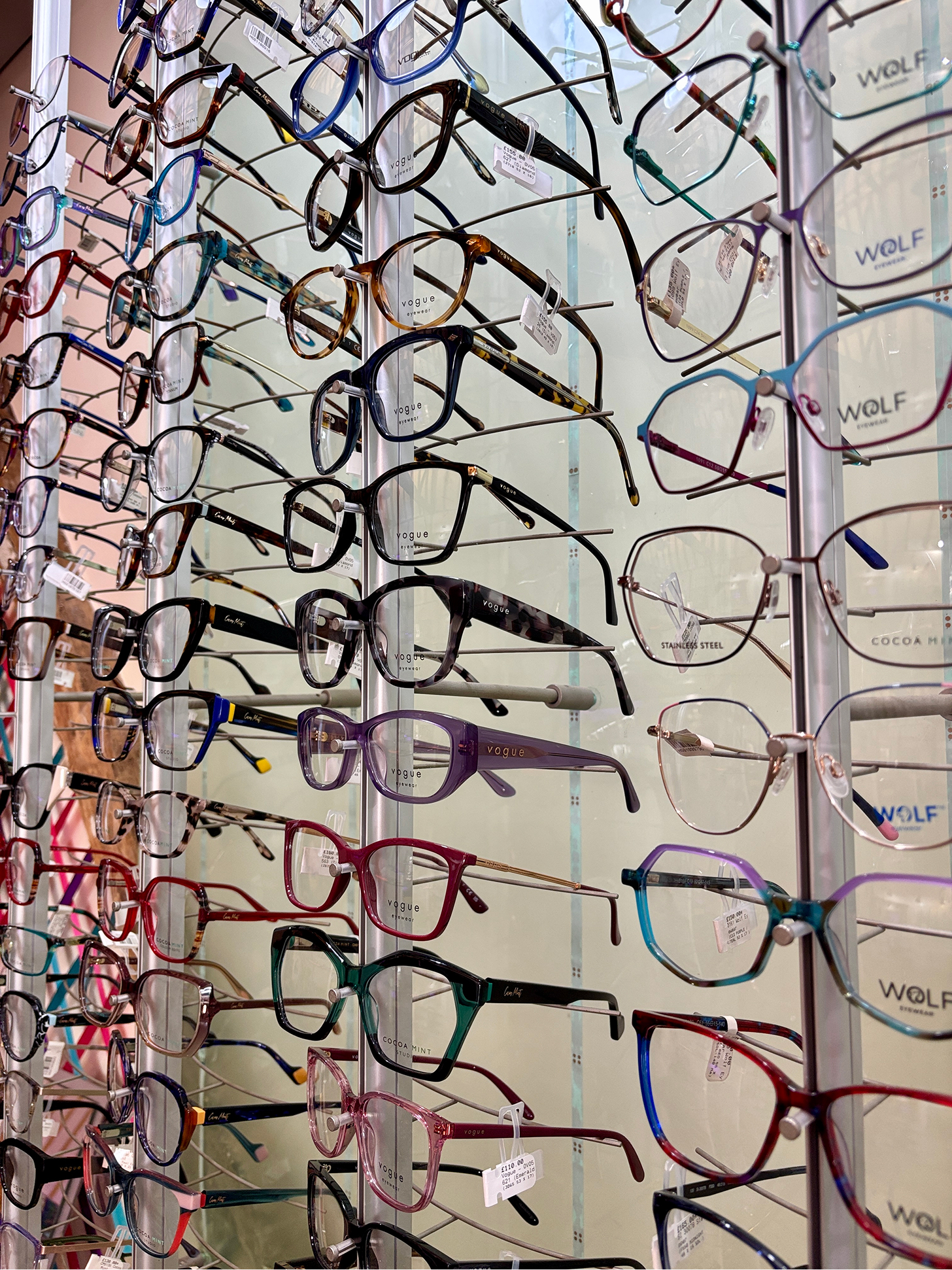 Colorful display of eyeglasses on display rack in optical store