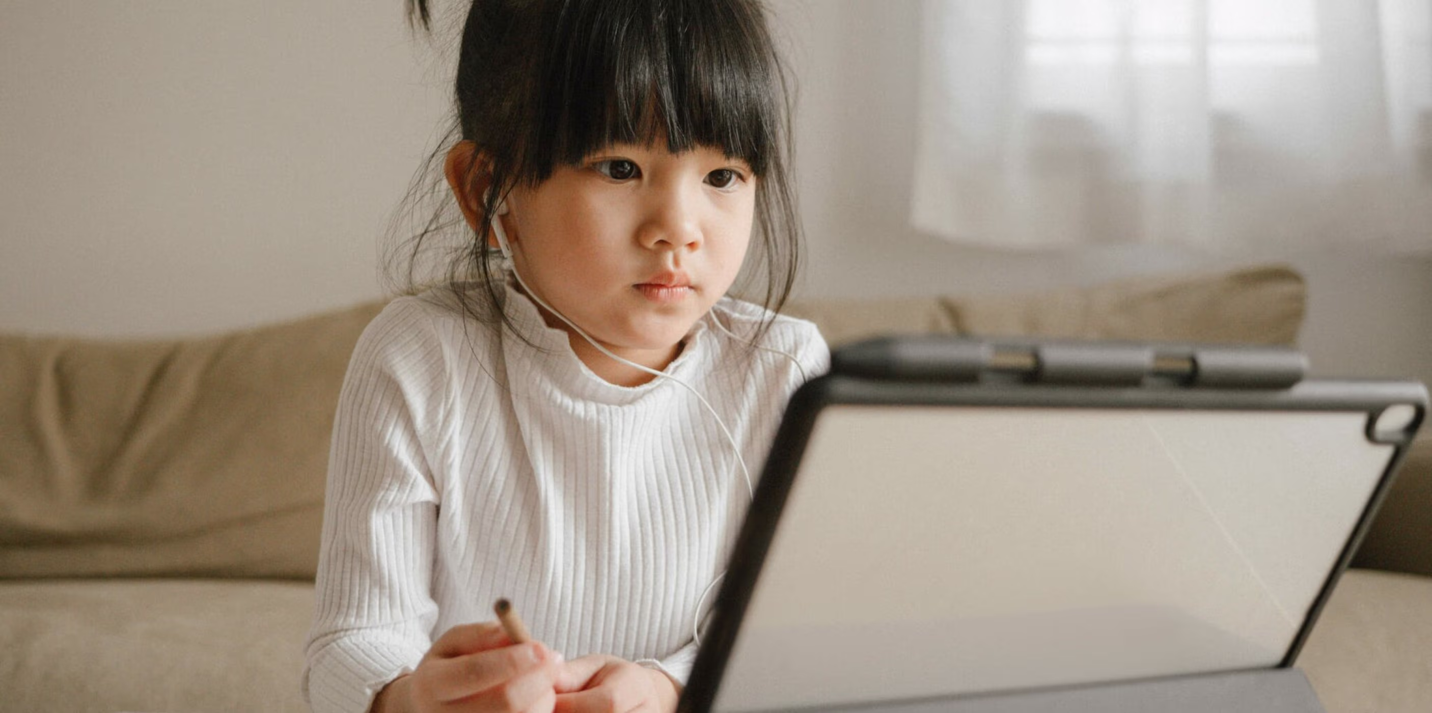 Young girl sat in front of a screen