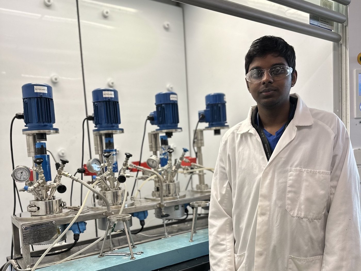 Dr Raj Lakshman with COOloop's catalyst test reactors in the laboratory
