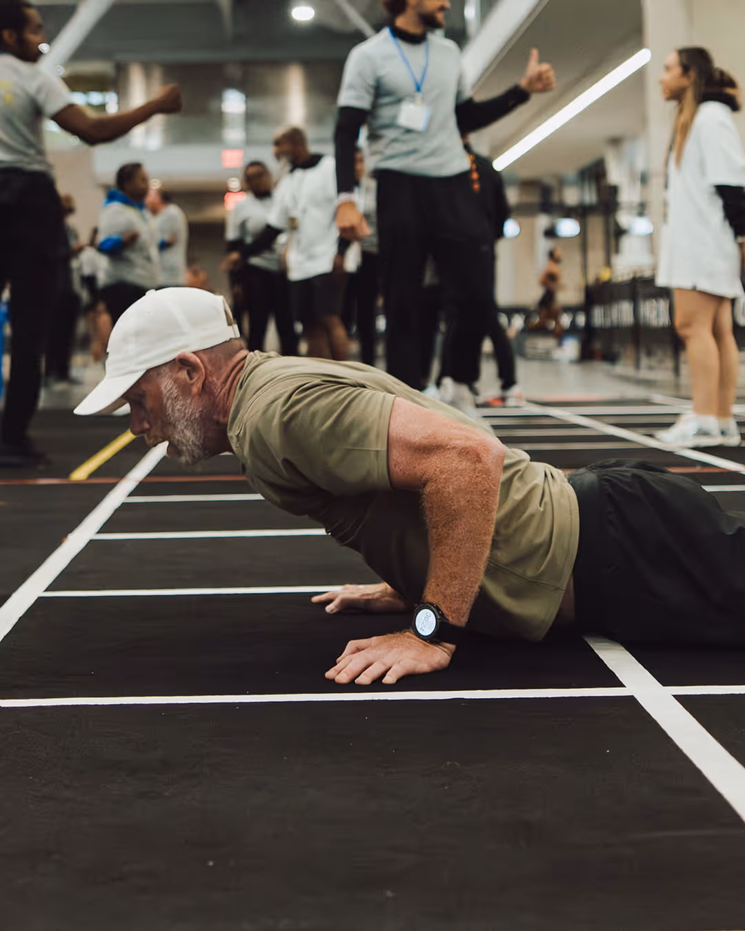 Man doing push-ups in a gym.