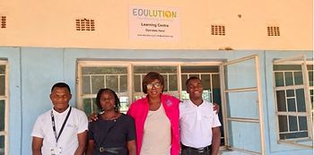 Edulution coaches standing with Zambia Ministry of Education staff and Headteacher