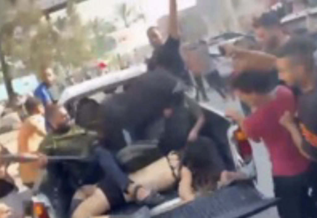 An Israeli woman's dead body in the back of a Hamas pickup truck