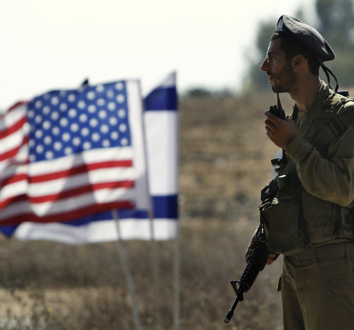 American and Israeli flag next to a soldier