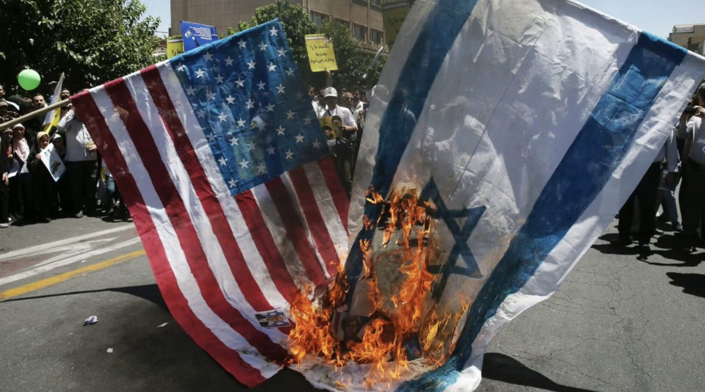 American and Israeli flags burning