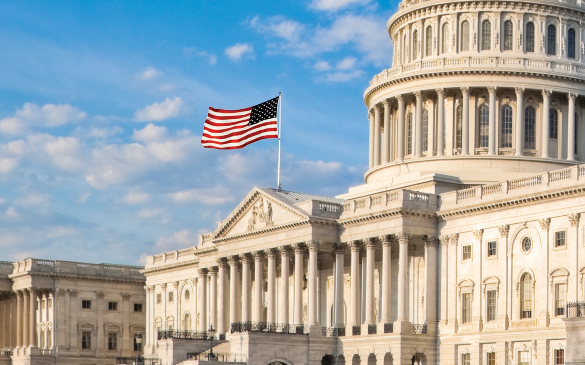U.S. capitol with American flag waving