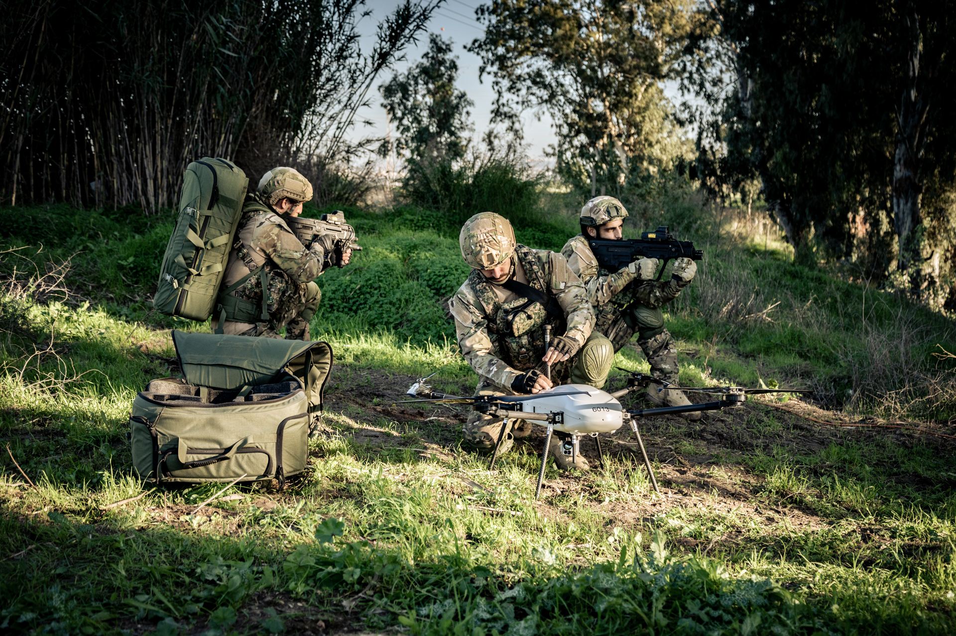 U.S. army soldiers in camo with a THOR backpack drone