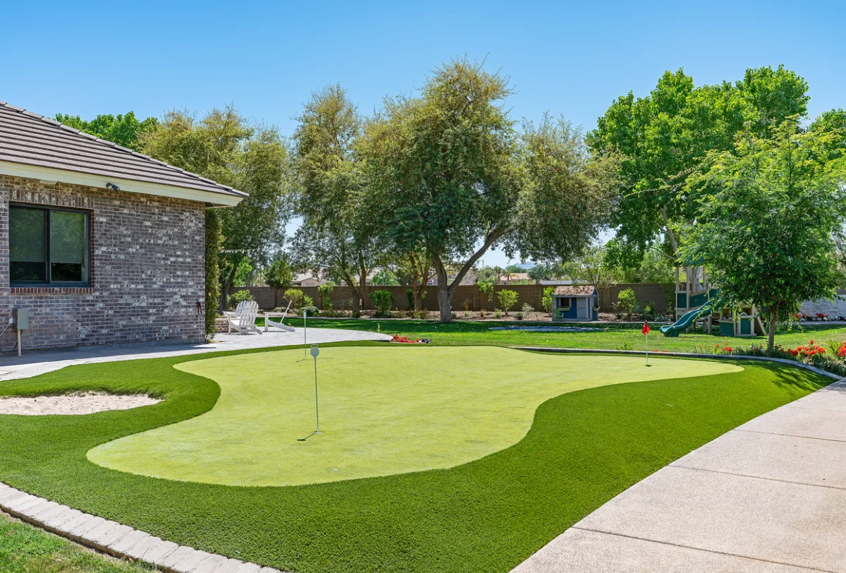 Artificial putting green installed in a residential backyard