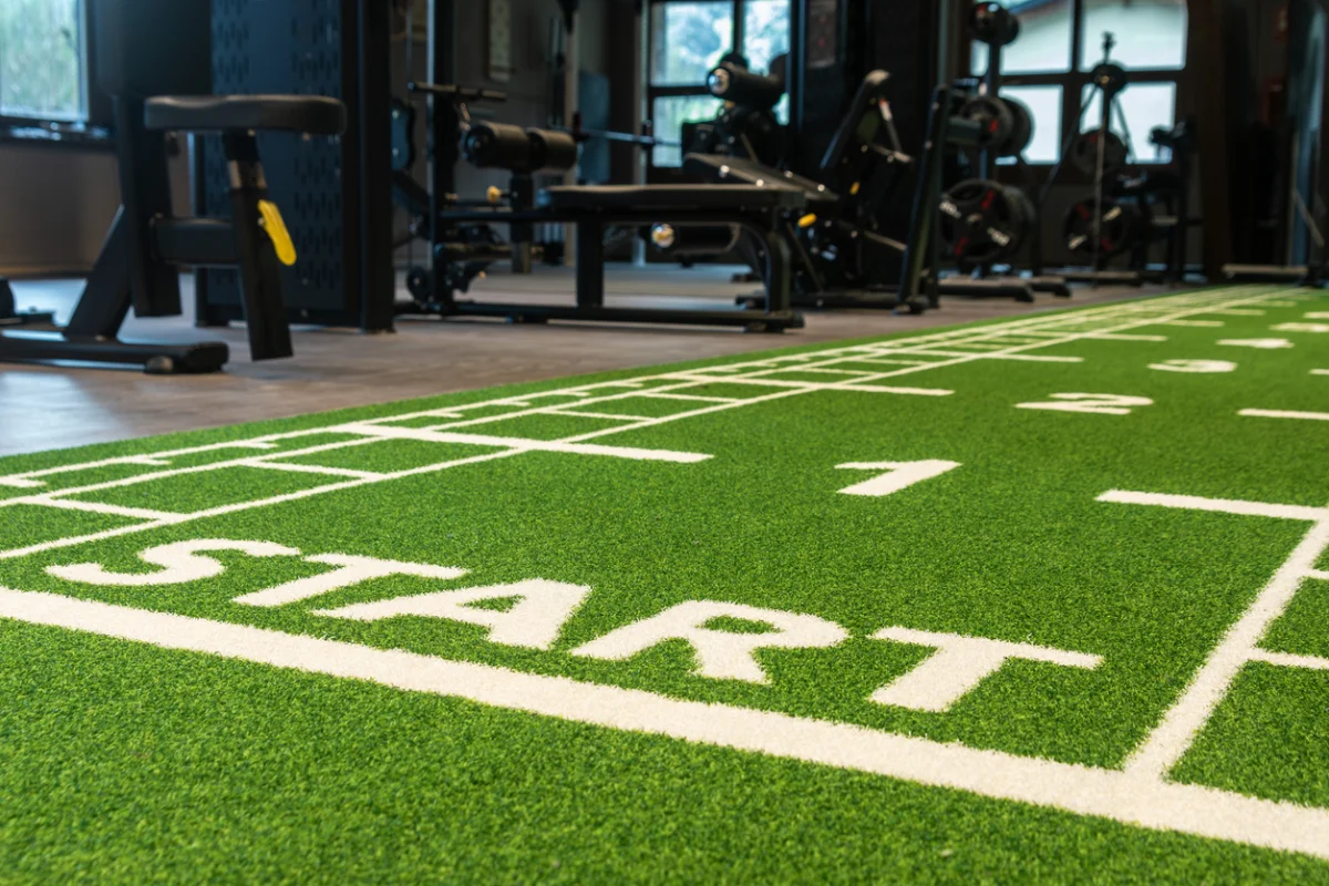 Commercial artificial turf flooring installed in an indoor gym facility