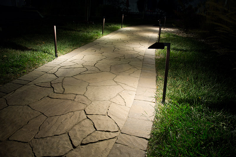 Pathway lighting installation enhancing visibility and safety in a landscaped yard