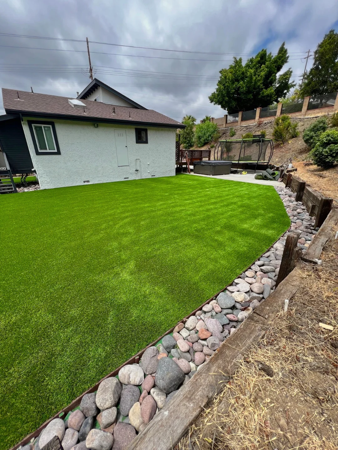 Backyard grading and drainage solution to manage water runoff