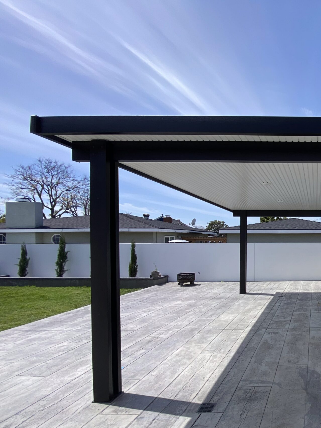 Front yard of a house with artificial grass and stepping stone pathway leading to the entrance.