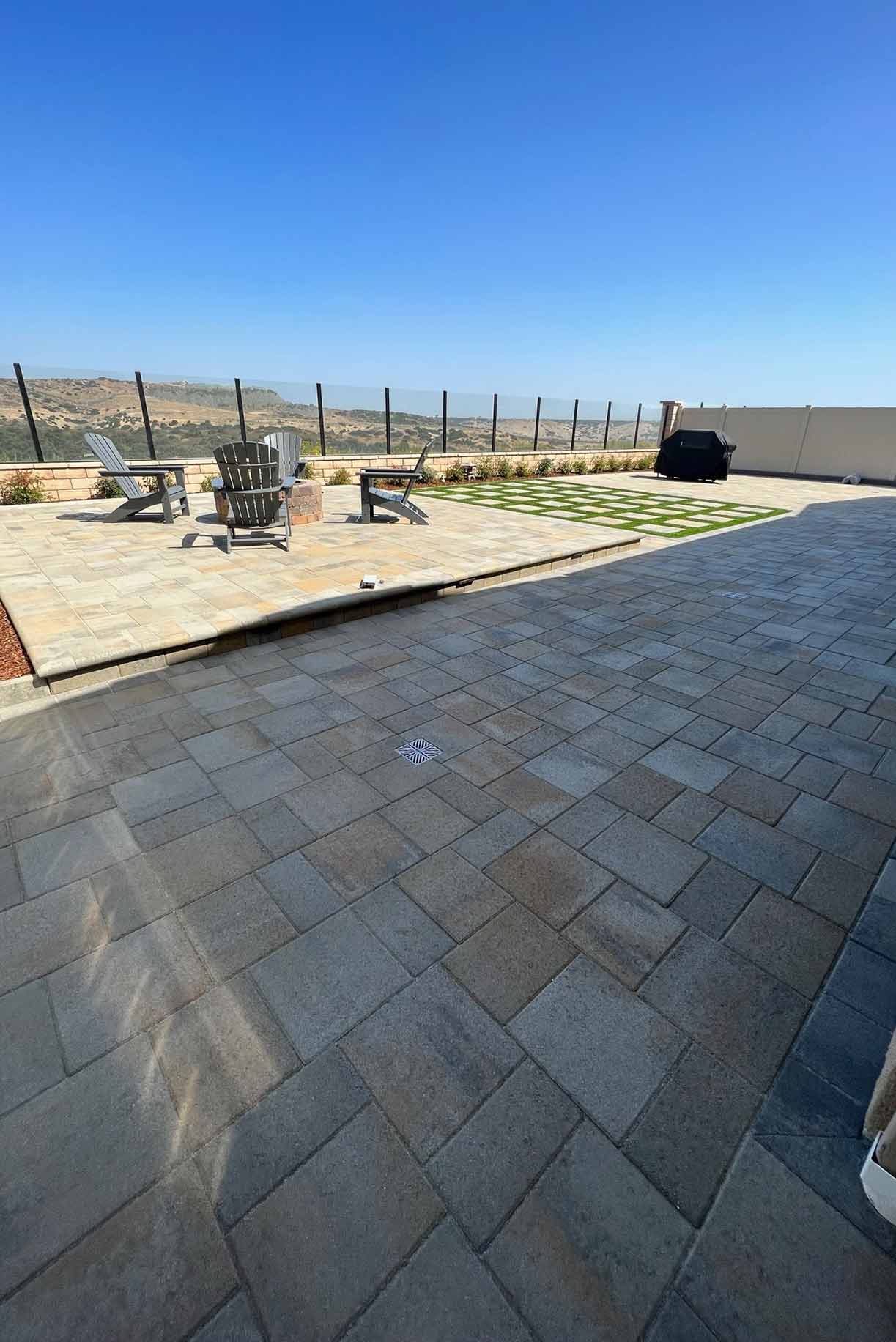 Front yard of a house with artificial grass and stepping stone pathway leading to the entrance.