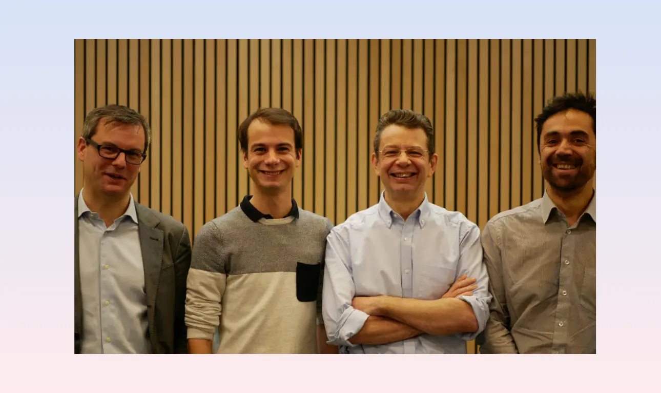 male holds a luminous labs red light therapy panel for a user, the light targets the face, the user is female and is smiling as the light rays feel good