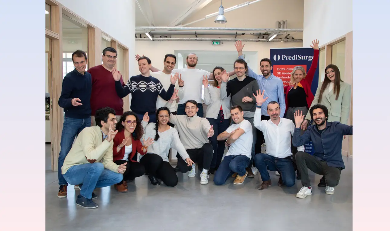 male holds a luminous labs red light therapy panel for a user, the light targets the face, the user is female and is smiling as the light rays feel good