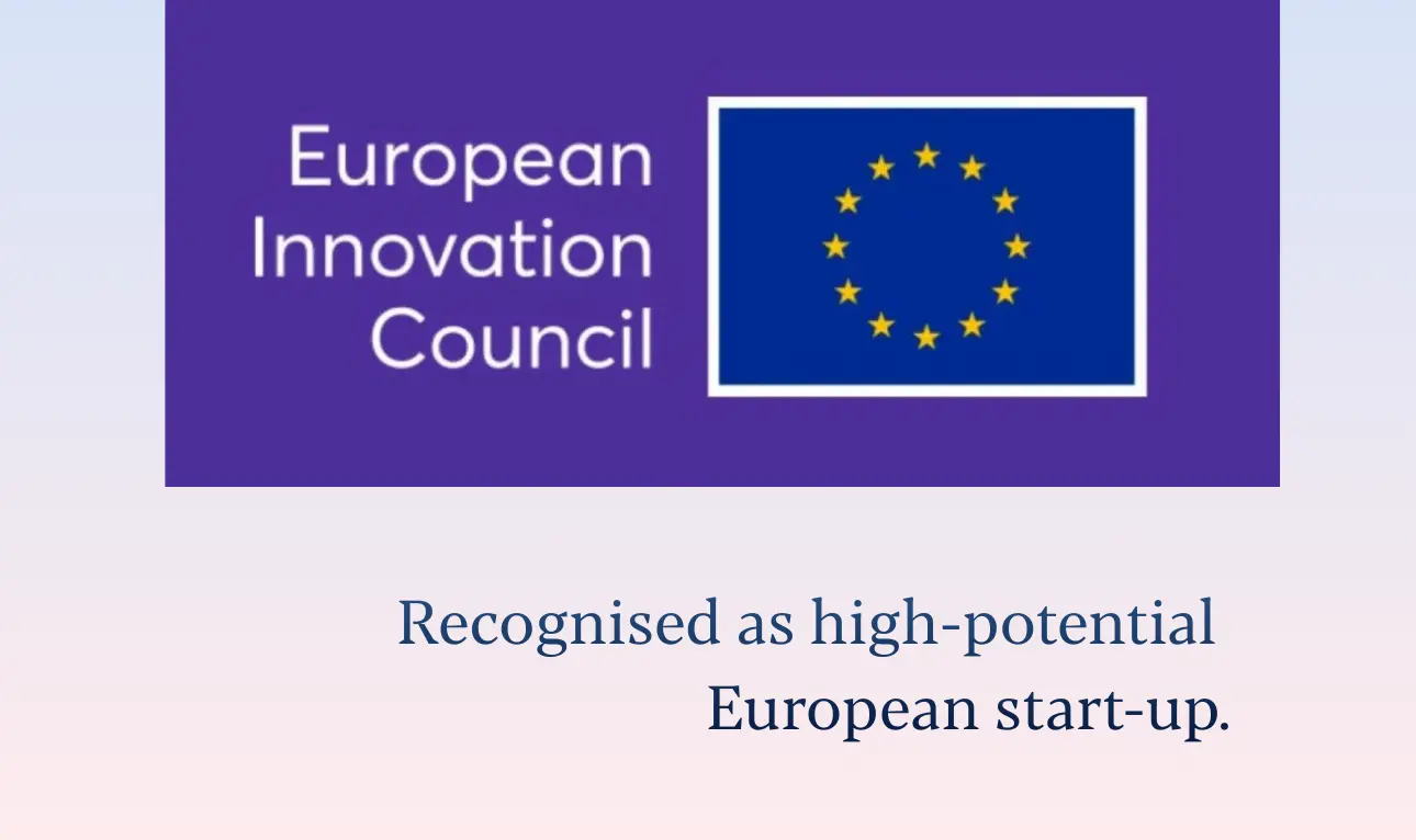 male holds a luminous labs red light therapy panel for a user, the light targets the face, the user is female and is smiling as the light rays feel good