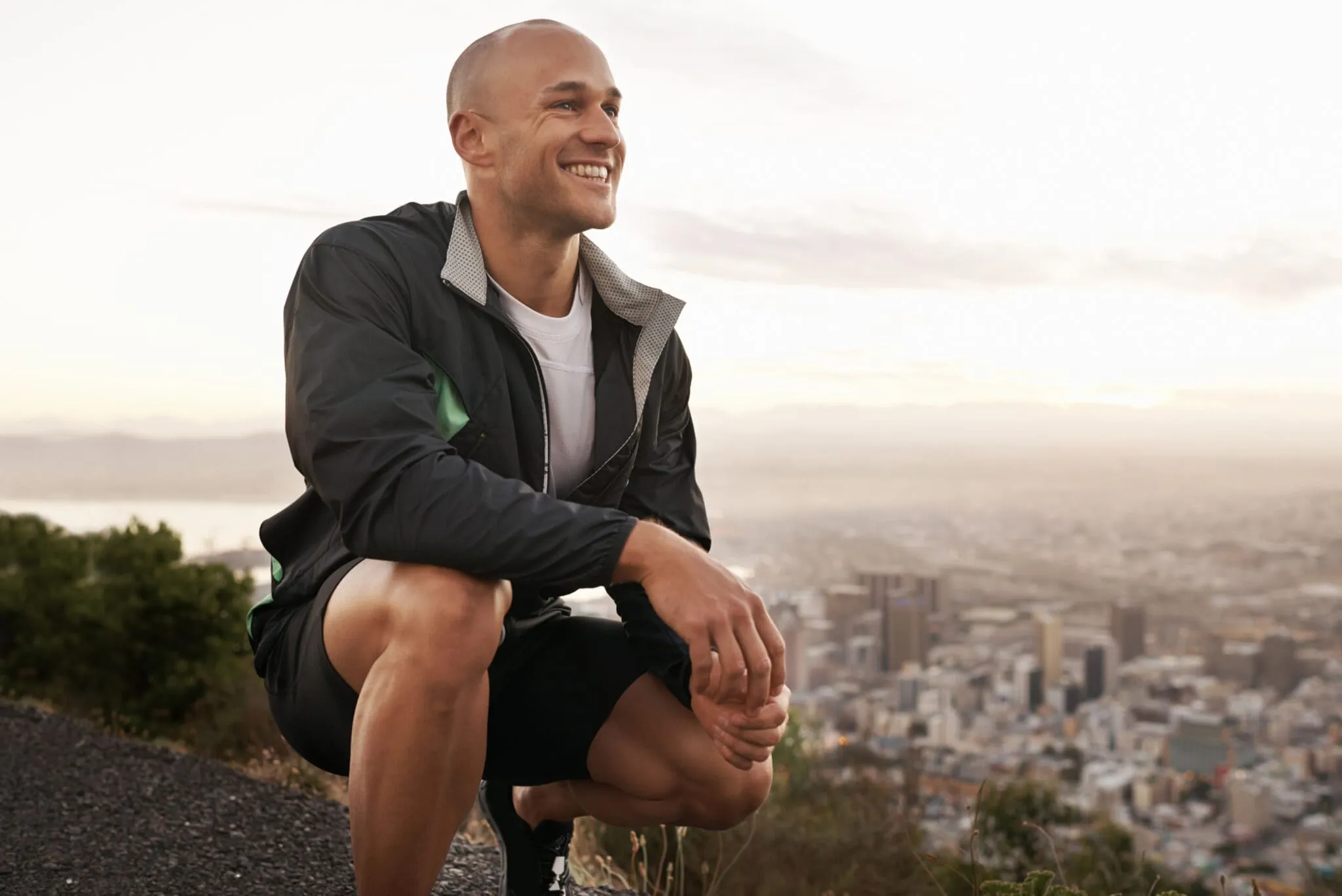 Athletic man outdoors smiling showcasing the postive link between testosterone replacement therapy, exercise, and overall quality of life.