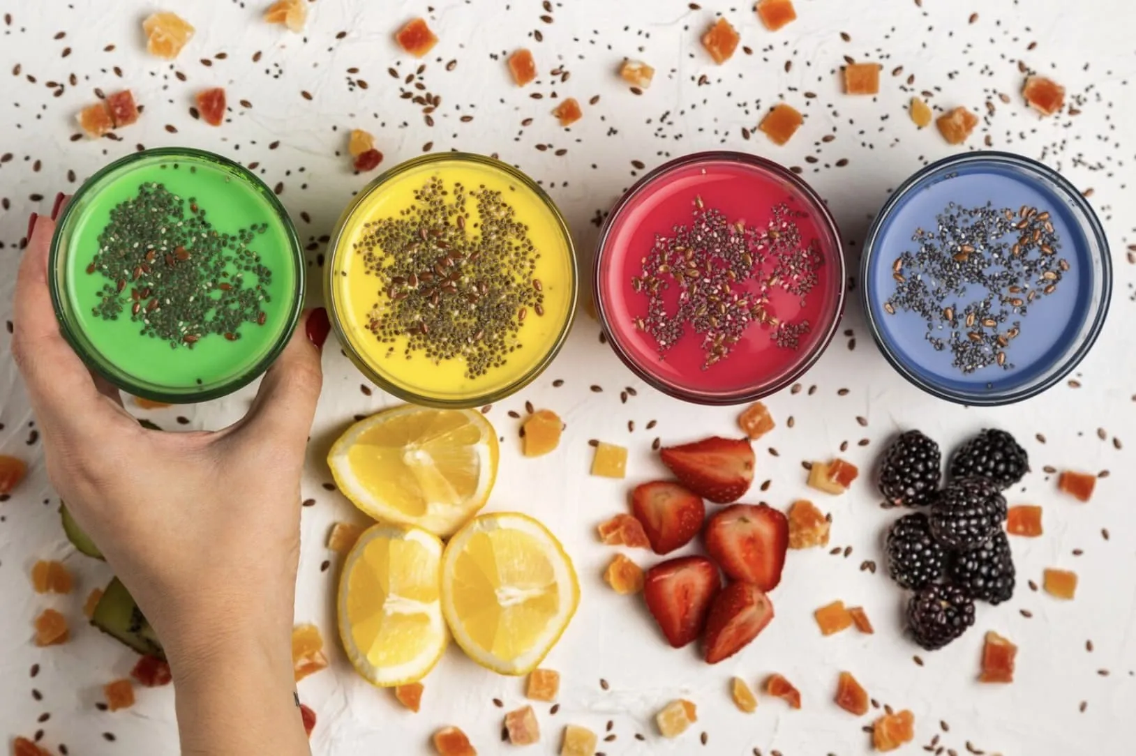 A refreshing glass of green smoothies made with spinach, berries, and pomegranate, representing natural drinks that boost blood flow and support better erectile function.