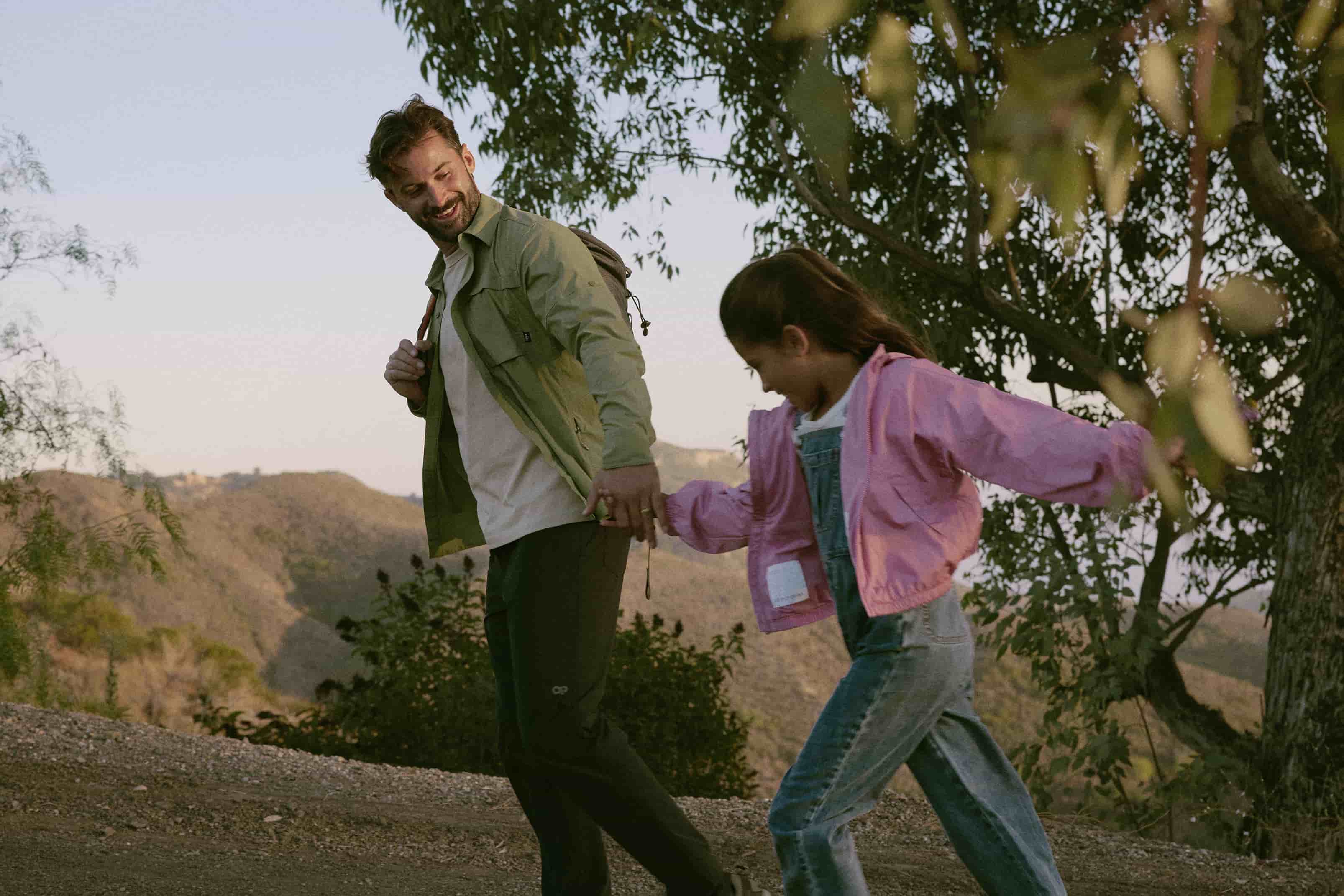 A father and daughter enjoying a hike together, representing the vitality and energy that can be gained through HGH therapy.