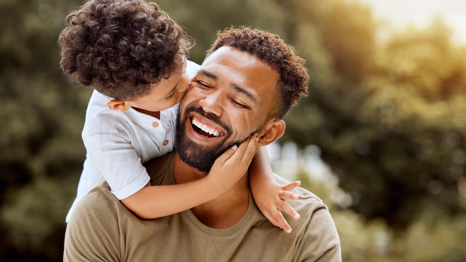 A father and his young son sharing a joyful moment, symbolizing the importance of testosterone optimization and overall well-being for men.