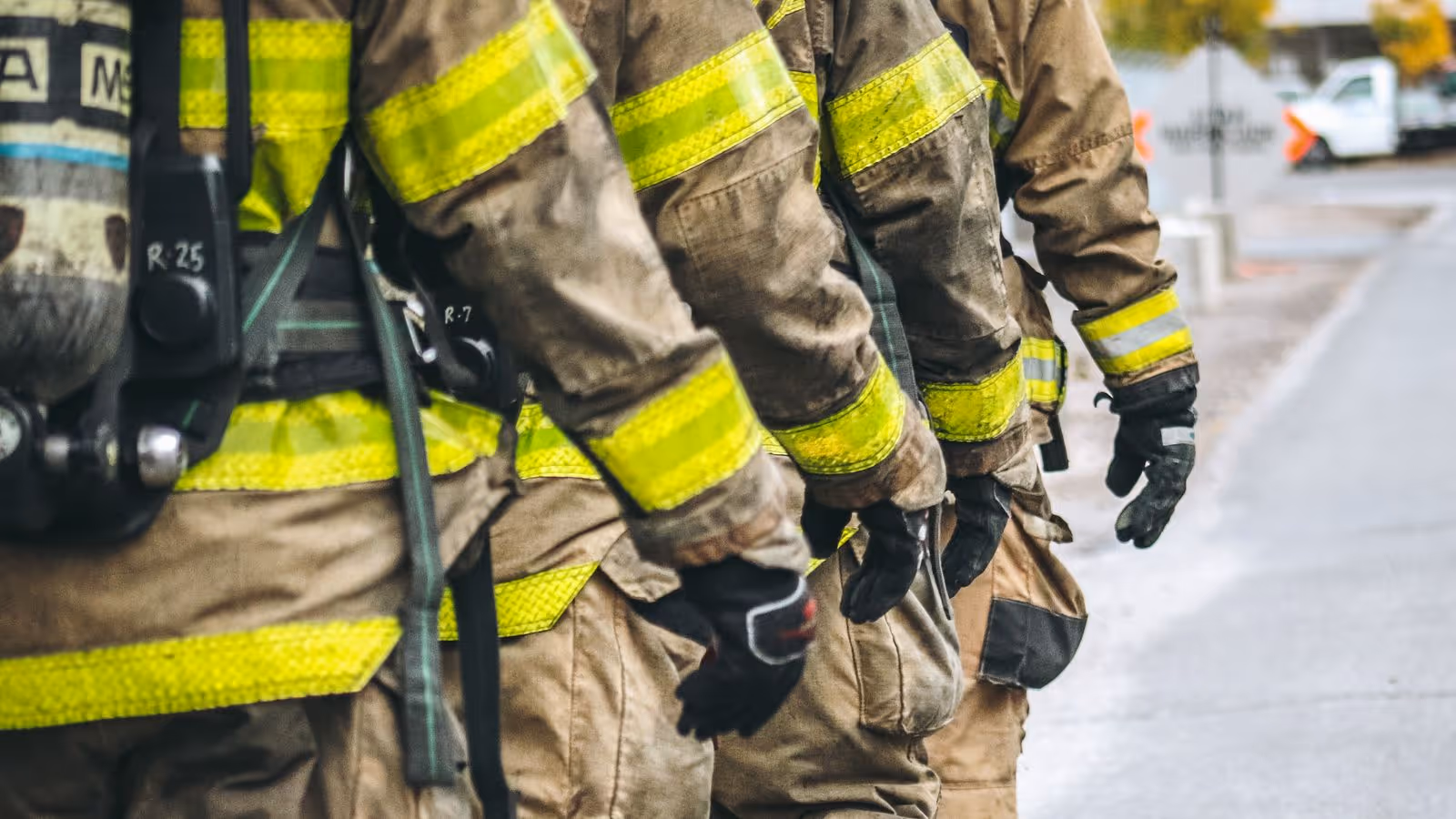 Group of firefighters in gear working together, representing the strength and stamina of first responders and how Gameday TRT can help boost focus and energy for demanding roles.