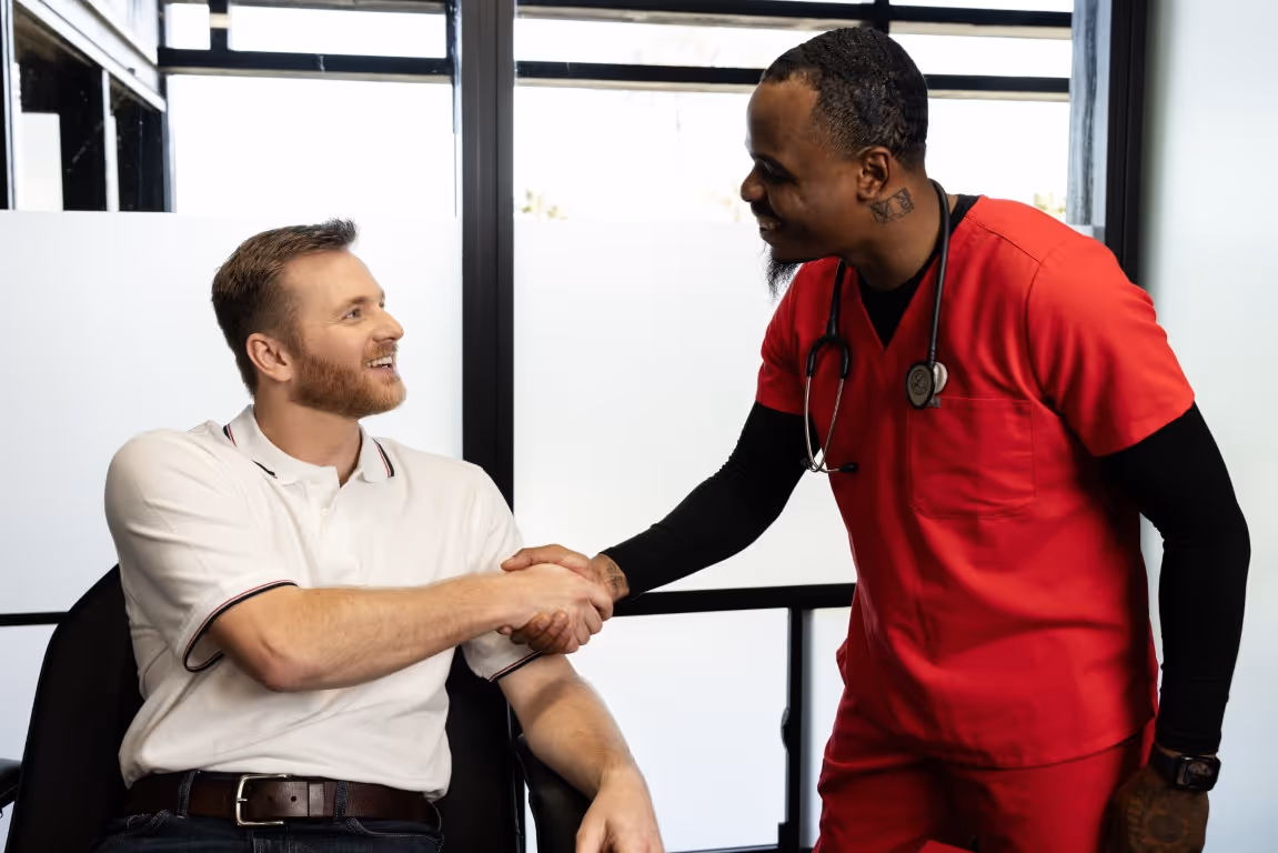 Healthcare provider shaking hands with a male patient during a clinic visit, representing trust, consultation, and key information patients need to know about the P Shot erectile dysfunction treatment.