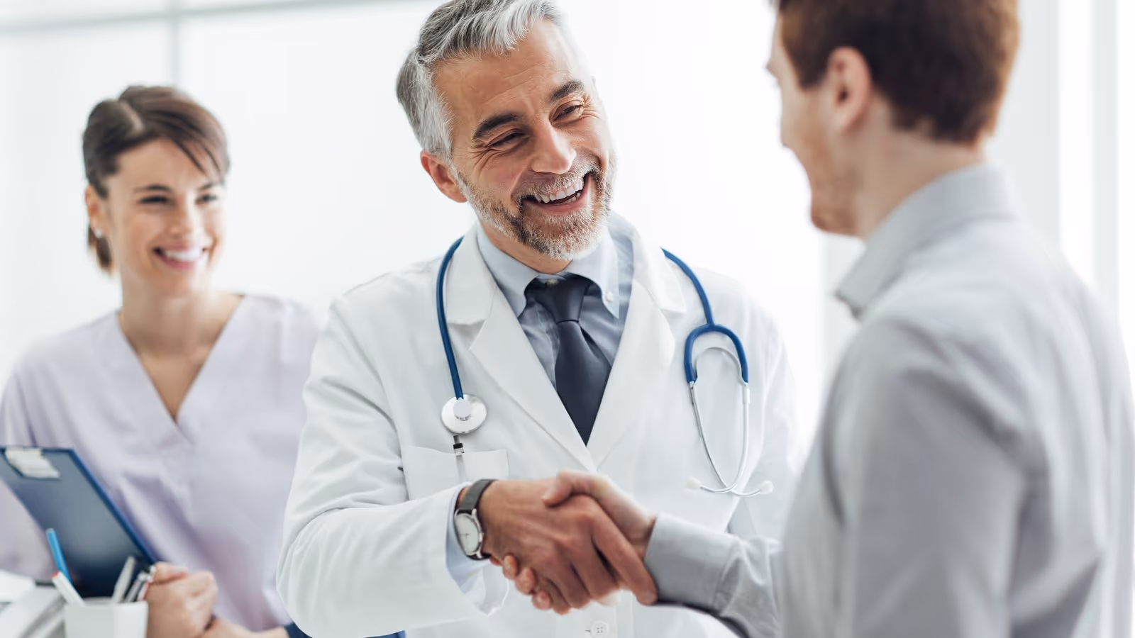 Doctor shaking hands with a male patient in a clinic, symbolizing trusted care and how men can maximize their health by using HSA and FSA benefits with Gameday.