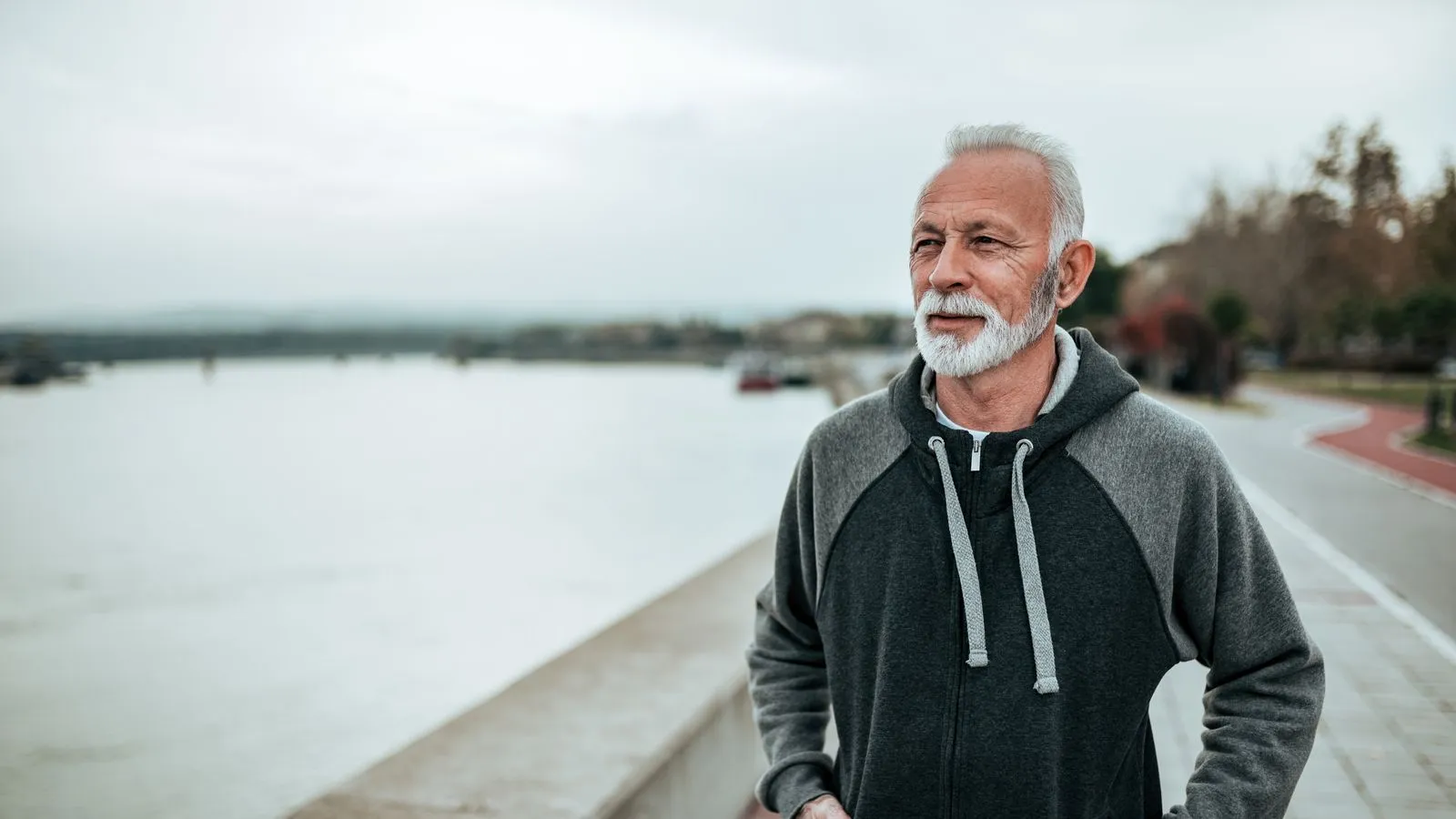 Active older man jogging along a waterfront path, representing improved energy, metabolism support, and overall wellness benefits associated with MIC lipotropic vitamin injections.