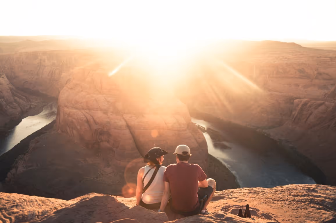 Couple sitting together at a scenic overlook during sunset, reflecting emotional connection, vitality, and lifestyle factors linked to how to increase libido in men.