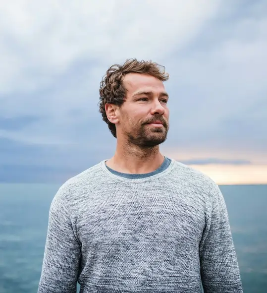 Man outdoors in a serene environment, representing enhanced immunity, energy, and detoxification from Glutathione antioxidant therapy.