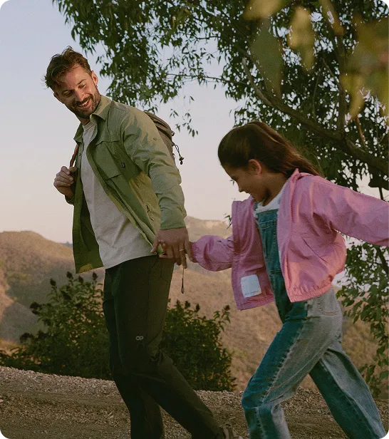 Father enjoying a hike with his daughter, illustrating the lifestyle benefits and improved well-being after receiving bioidentical testosterone pellet treatment.