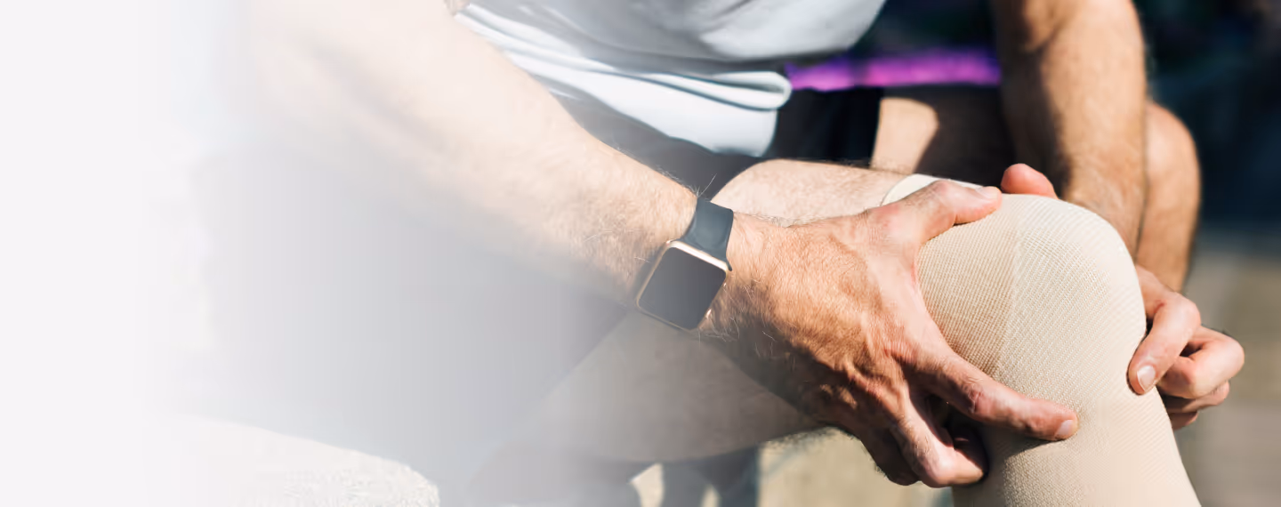 Man holding his knee during physical discomfort, illustrating how EPAT shockwave therapy is used to relieve pain, promote healing, and support recovery from musculoskeletal injuries.