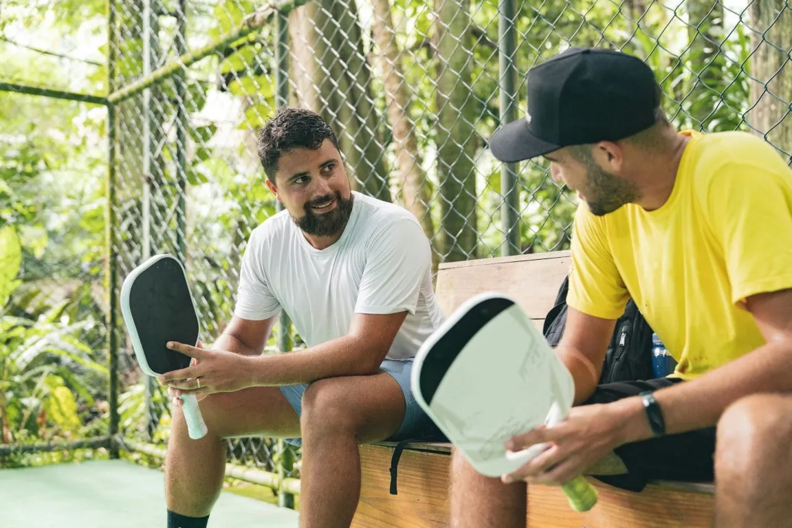 Two men resting after a pickleball game on an outdoor court, representing lifestyle changes and activity levels discussed in how soon semaglutide works for weight loss and metabolic health.