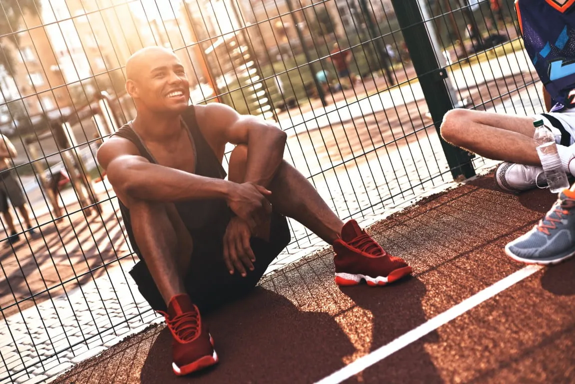Active man resting on an outdoor court after exercise, representing improved fitness, energy, and lifestyle changes explained in a semaglutide beginner’s guide for weight management and metabolic health.