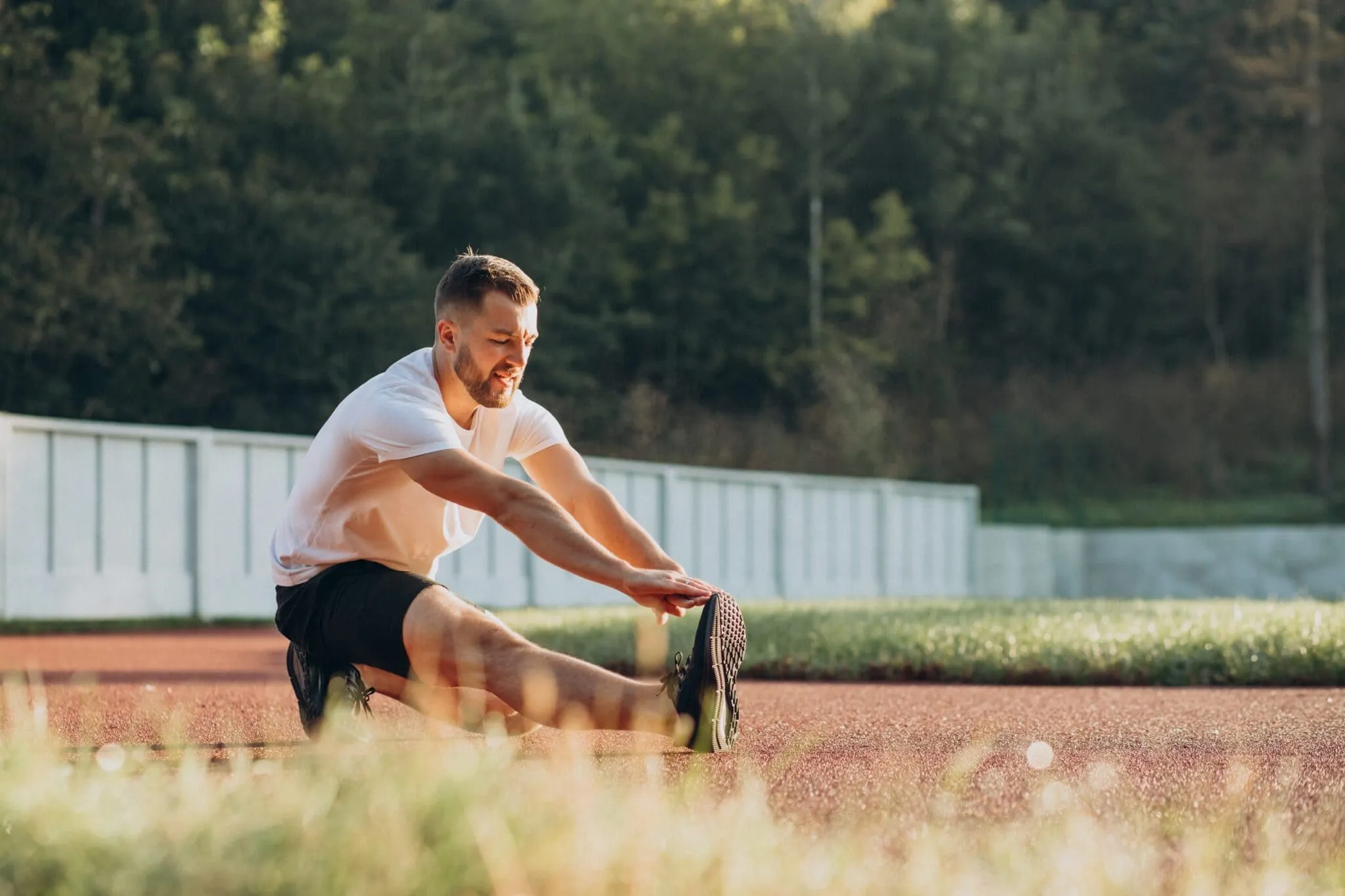 Man in good shape stretching, highlighting fitness and weight loss benefits linked with GLP-1 treatments.