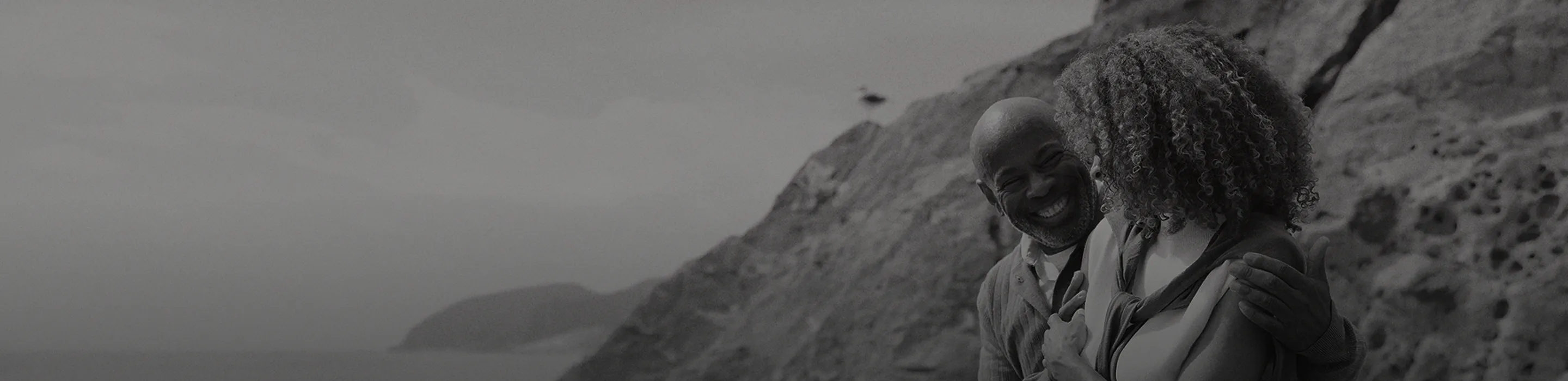 Smiling couple sitting together in the mountains, symbolizing restored intimacy, confidence, and sexual wellness supported by Gameday Men’s Health ED treatments.