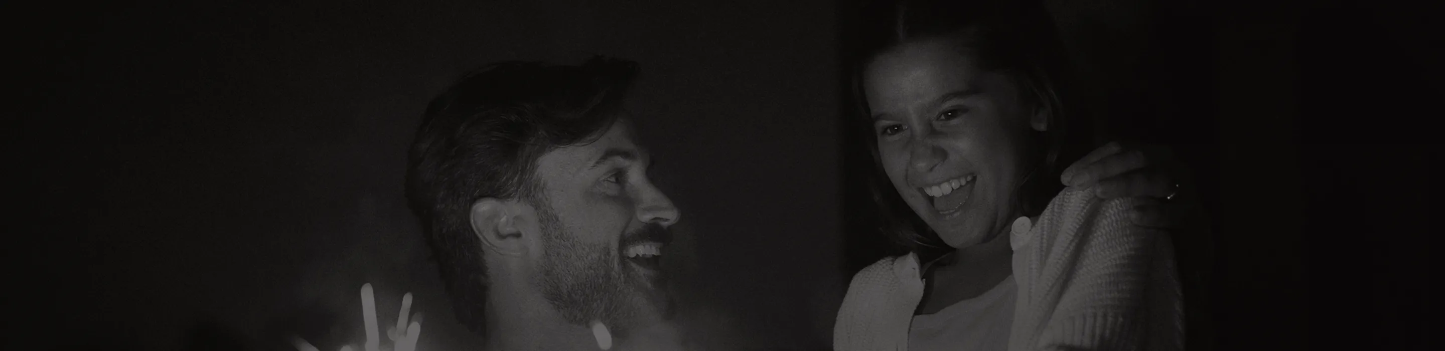 Smiling father and daughter celebrating outdoors with sparklers, reflecting the long-term benefits of anti-aging and hormone optimization at Gameday Men’s Health.