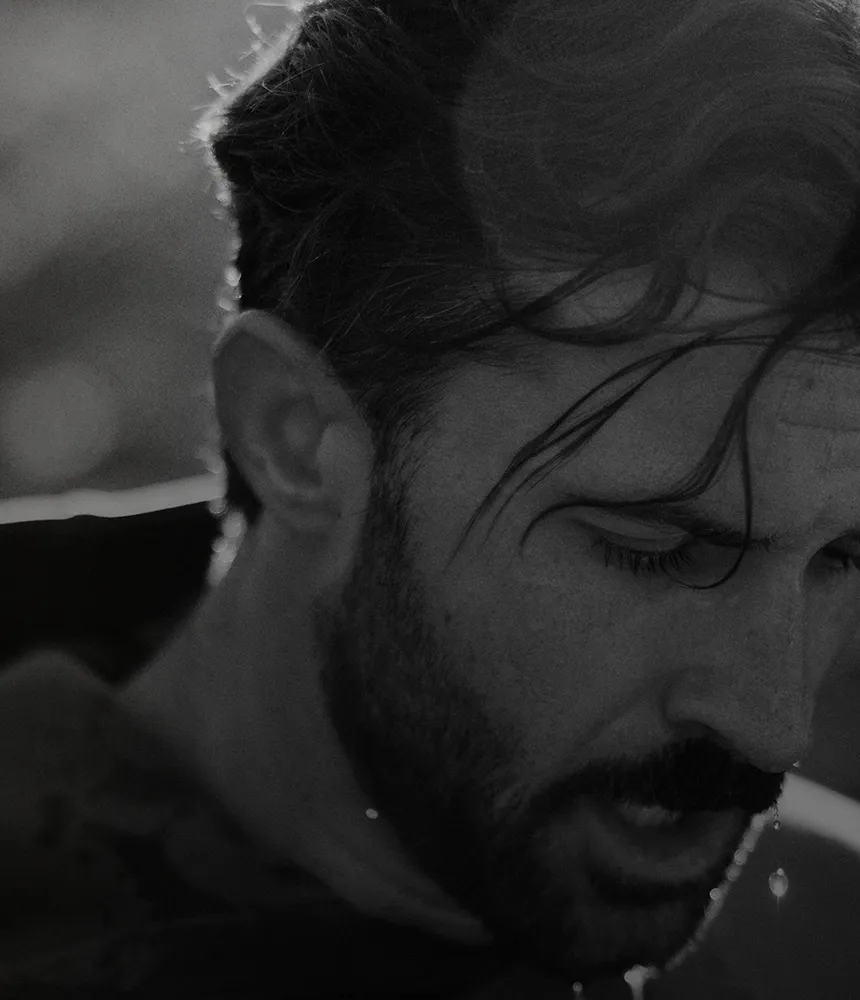 Man catching his breath after a workout, looking thoughtful as he considers hair thinning and long-term hair loss treatment options for men at Gameday Men’s Health.