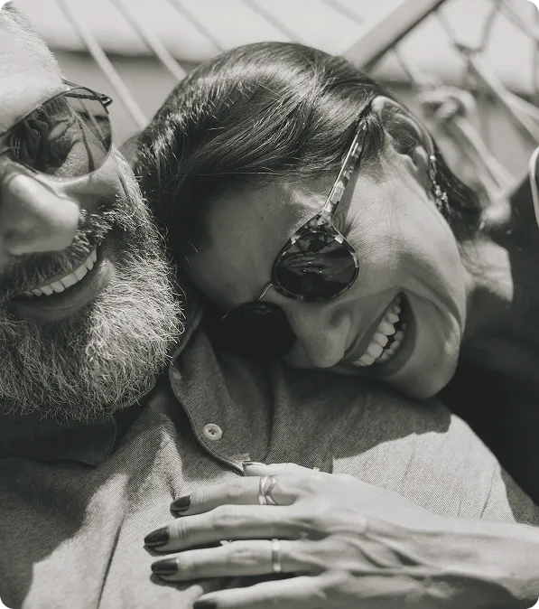 Middle-aged couple smiling and embracing outdoors, representing confidence and improved sexual health with Viagra® and Cialis® treatment