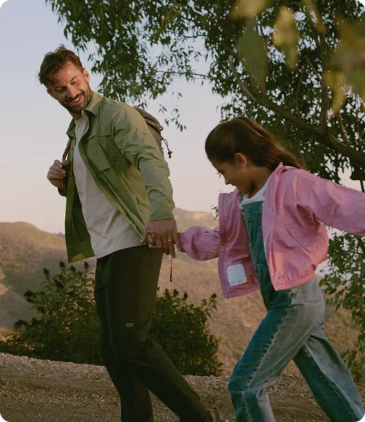 Father enjoying a hike with his daughter, illustrating the lifestyle benefits and improved well-being after receiving bioidentical testosterone pellet treatment.