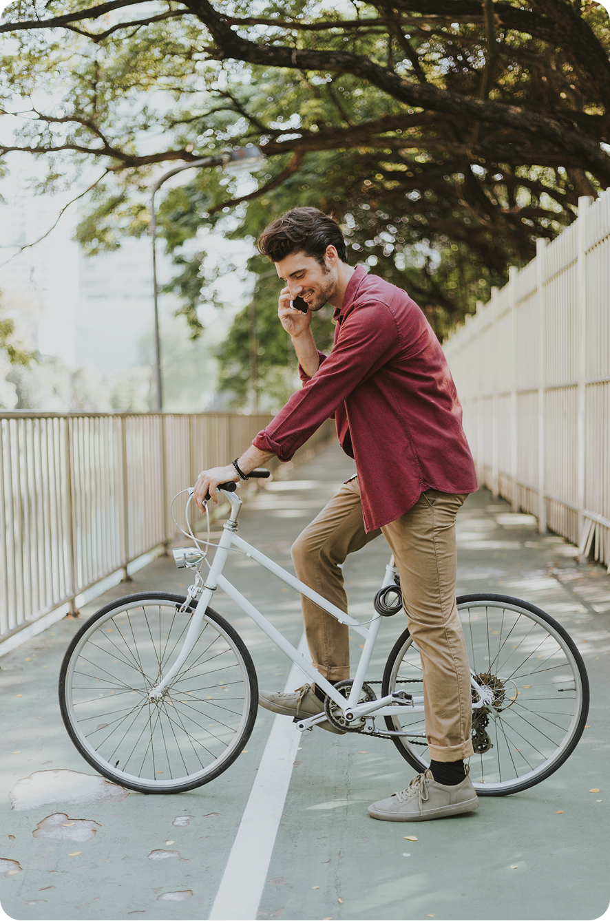Man resting on a bike during an outdoor ride, symbolizing energy, motivation, and daily performance supported by hormone therapy in Syracuse, NY.
