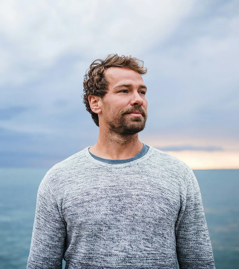 Man outdoors in a serene environment, representing enhanced immunity, energy, and detoxification from Glutathione antioxidant therapy.